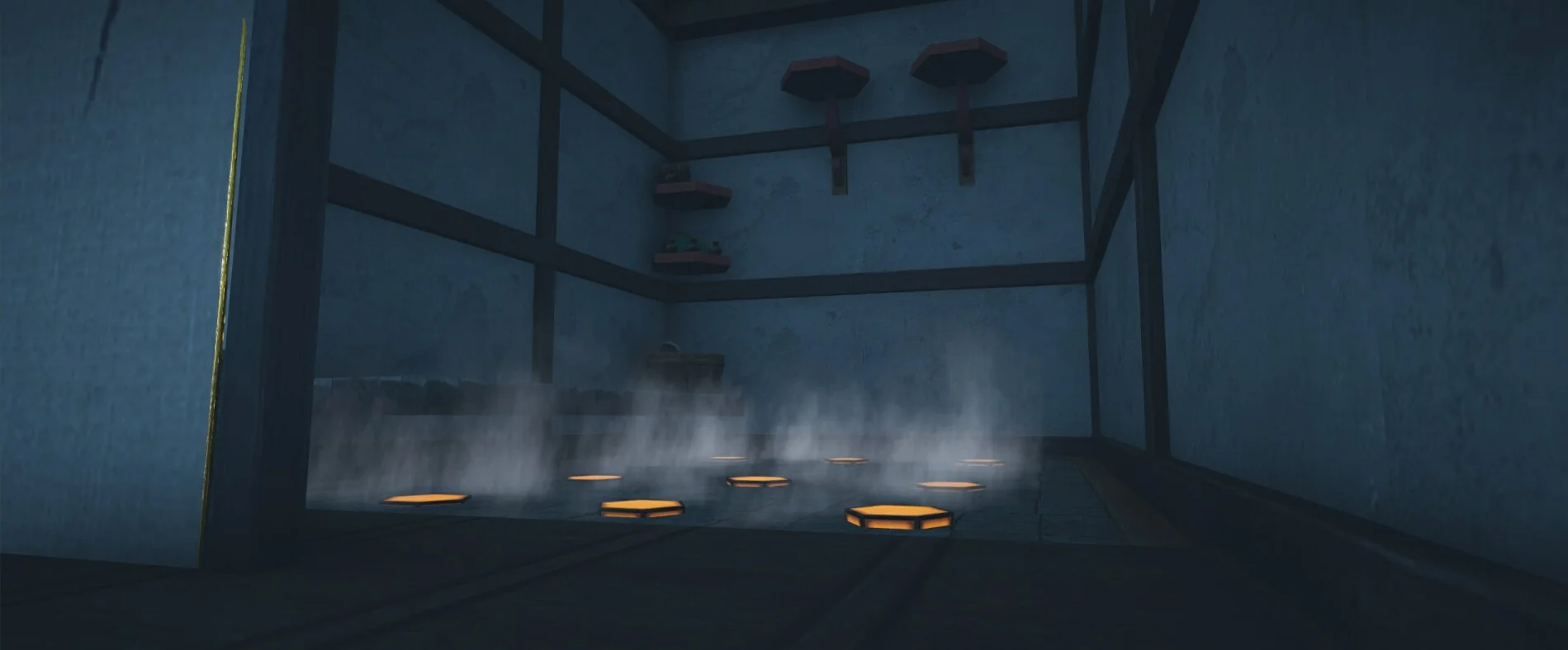 Dark room with heating pads on the floor producing rising steam